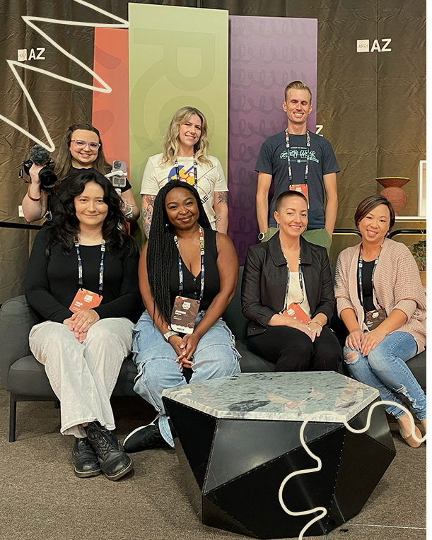 the phdxw social team smiling and sitting on the stage